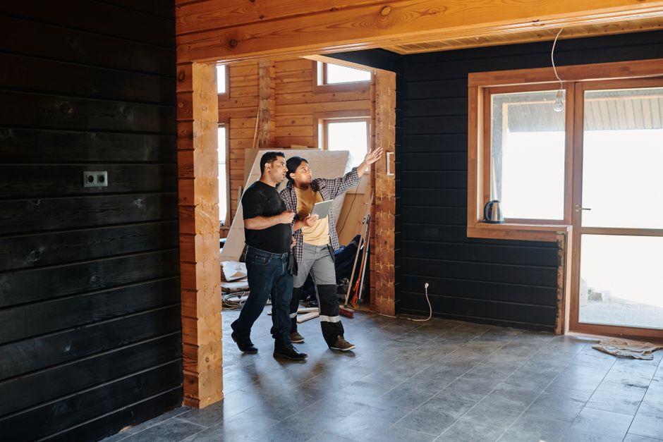 Contractor planning a kitchen remodel over architectural blueprints