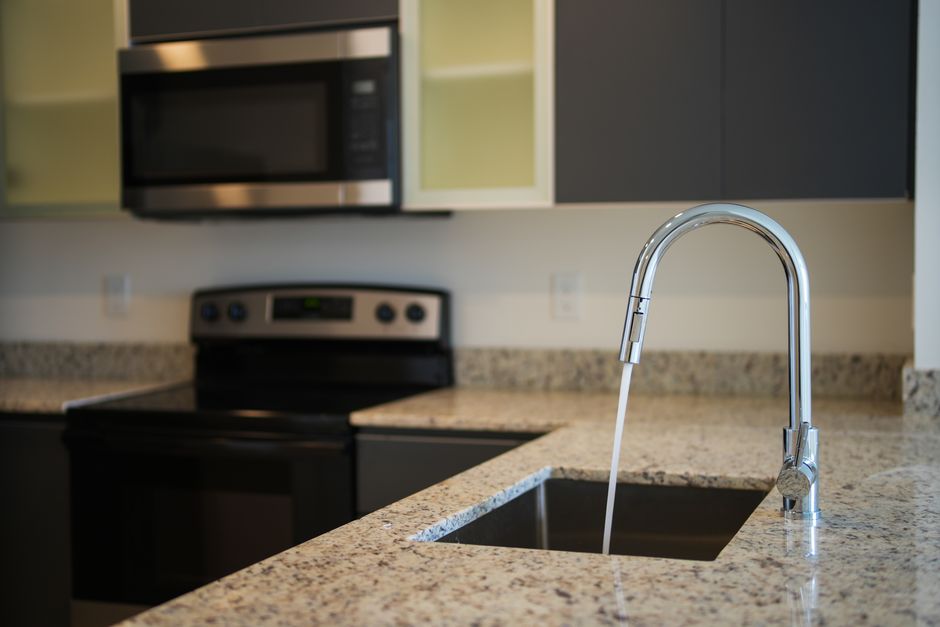 Modern kitchen sink faucet in a newly remodeled space